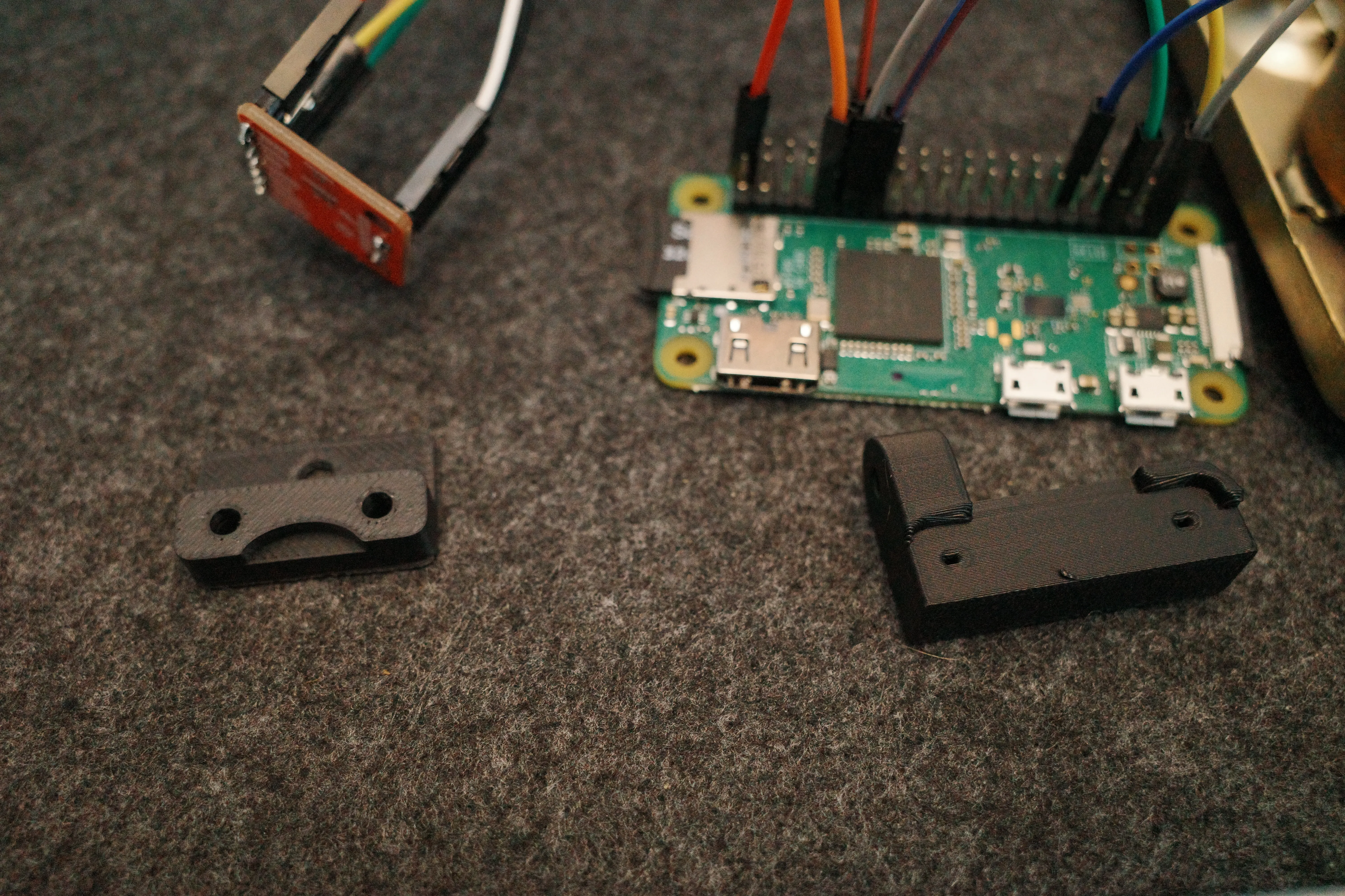 Raspberry Pi, amplifier breakout, and black 3D-printed mounting parts