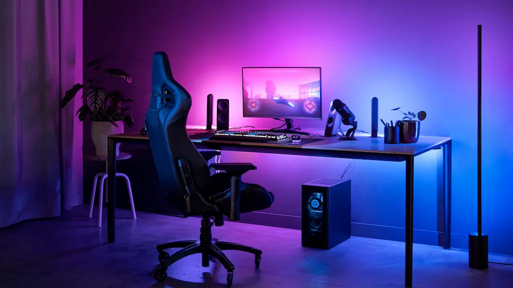 A desk setup with VS Code and a Philips Hue lamp flashing as a status indicator for Codex.